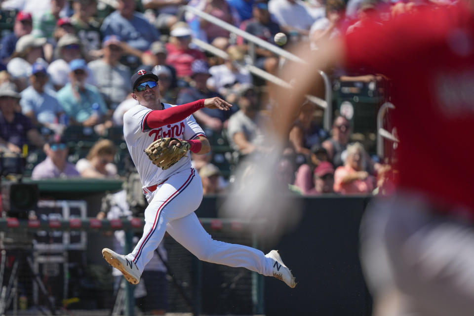 Minnesota Twins third baseman Andrew Bechtold (89) tries to throw out Boston Red Sox Bobby Dalbec on his single in the third inning of a spring training baseball game in Fort Myers, Fla., Saturday, March 11, 2023. (AP Photo/Gerald Herbert)