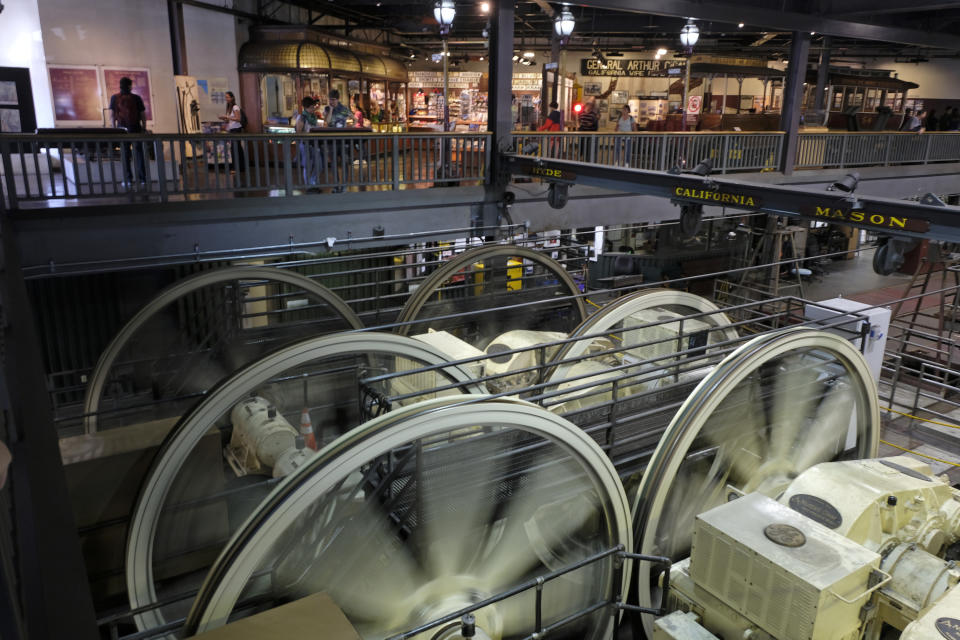 Sheaves turn by gearboxes inside the cable car powerhouse Wednesday, Sept. 11, 2019, in San Francisco. San Francisco's iconic cable cars will stop running for 10 days starting Friday to undergo repairs. The city's transit agency says it needs to get the manually operated cable cars off the street to rehabilitate the gearboxes that power the system that started in the 1890s. Shuttle buses will instead transport people along the steep streets of the cable car routes. (AP Photo/Eric Risberg)