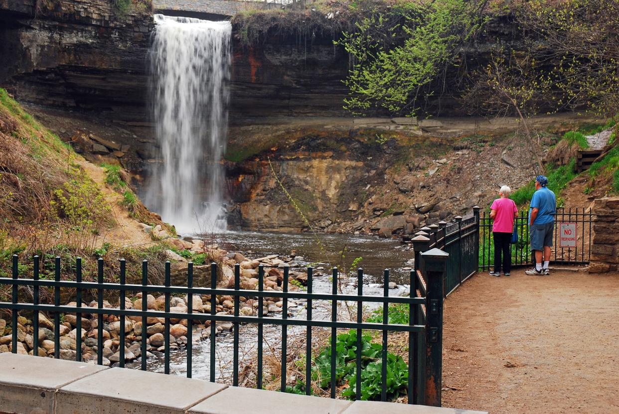 Minneapolis, MN, USA May 13, 2013 An adult couple stop to take in the view Minnehaha Falls in Minneapolis, Minnesota