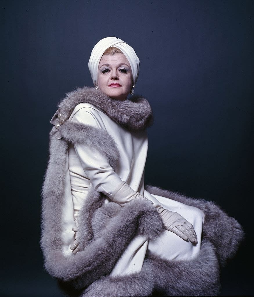 Angela Lansbury taking a portrait wearing a fur coat