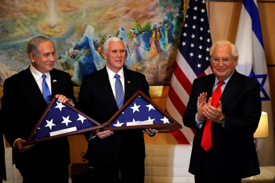 Israeli Prime Minister Benjamin Netanyahu and U.S Vice President Mike Pence display gifts they received from U.S Ambassador to Israel David Friedman during their meeting at the U.S embassy in Jerusalem