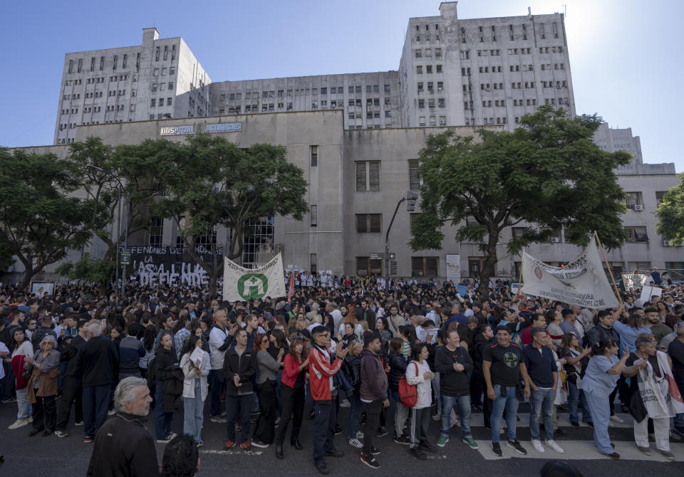 Personal médico y estudiantes protestan fuera del Hospital de Clínicas, al fondo, que depende financieramente de la Universidad de Buenos Aires (UBA), contra el congelamiento presupuestario de la UBA dispuesto por el presidente argentino, Javier Milei, como parte de sus medidas de austeridad en Buenos Aires, Argentina, el jueves 18 de abril de 2024. (AP Foto/Víctor R. Caivano)