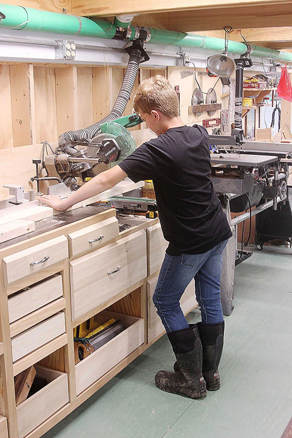 Aiden Sumler works in the woodshop at Pathfinder Farms. TONY ORENDER/For ASHLAND-TIMES-GAZETTE