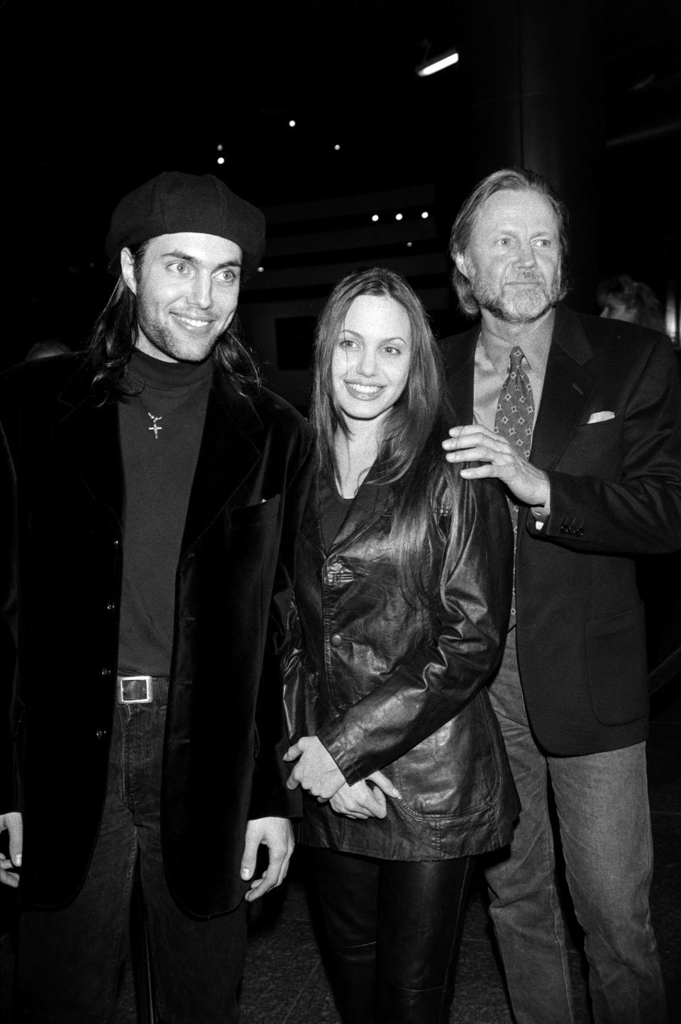 (L-R) James Haven, Angelina Jolie, and Jon Voight attend an event at the headquarters of the Directors Guild of America in Los Angeles, California, on February 16, 1994. (Photo by Ted Dayton/WWD/Penske Media via Getty Images)