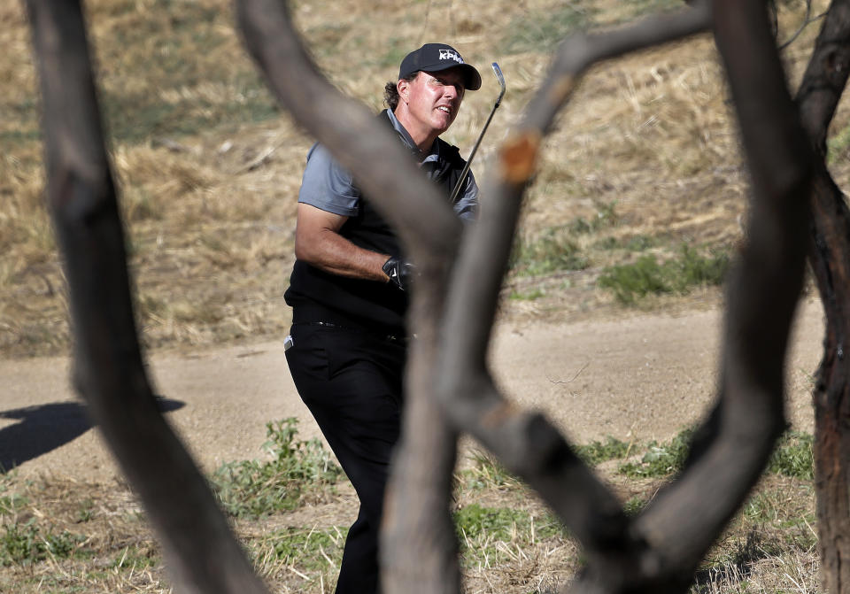 Phil Mickelson watches his shot from desert area off the ninth fairway during the second round of the Phoenix Open PGA golf tournament, Friday, Feb. 1, 2019, in Scottsdale, Ariz. (AP Photo/Matt York)