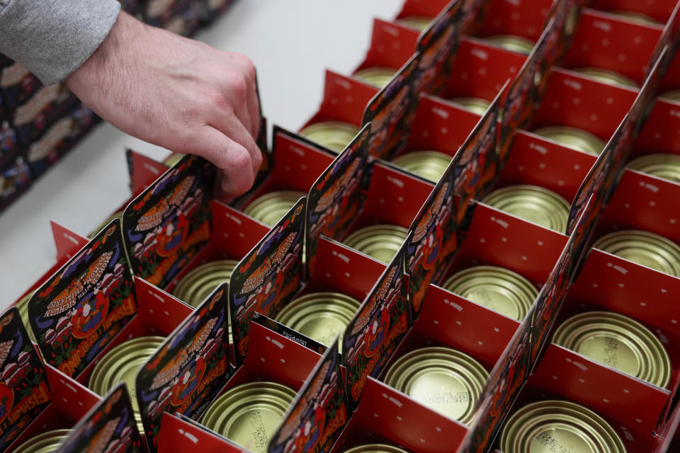 A worker helps package products for Fishwife, a Los Angeles-based tinned fish company, Friday, Oct. 13, 2023, at a cannery in Bay Center, Wash. (AP Photo/Lindsey Wasson)