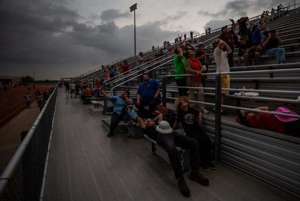 People celebrate the solar eclipse reaching totality at the Eagle Pass Independent School District Student Activities Center in Eagle Pass on April 08, 2024.