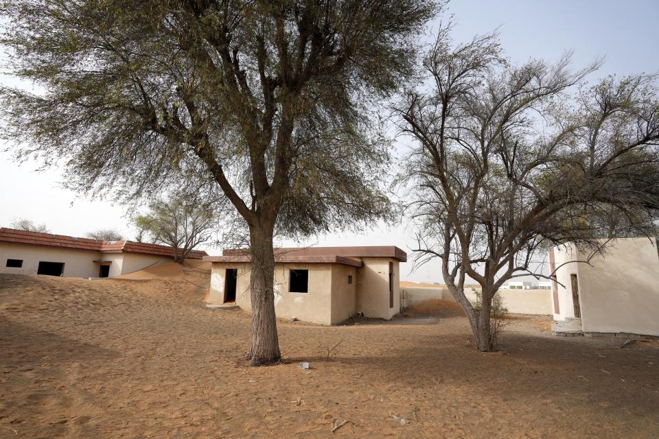 Houses are seen buried under the sand at the Bedouin village of al-Ghuraifabout 100 km, 62 miles, southeast of Sharjah, United Arab Emirates, Sunday, July 9, 2023. Built-in the 1970s, the village was abandoned two decades later as oil wealth transformed the country into a global hub of commerce and tourism, home to the futuristic cities of Dubai and Abu Dhabi. (AP Photo/Kamran Jebreili)