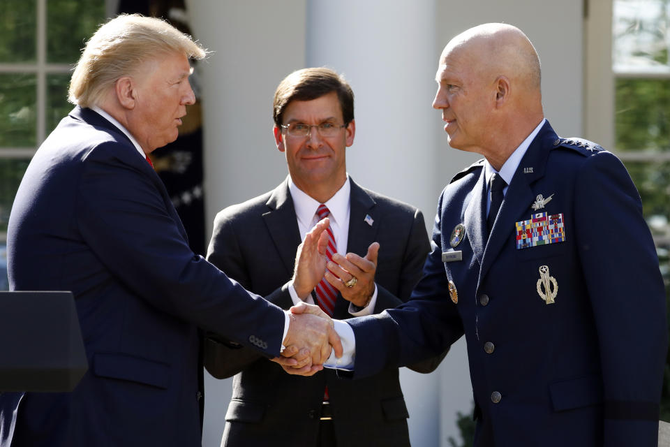 President Donald Trump shakes hands with Gen. Jay Raymond, commander of Air Force Space Command, as Defense Secretary Mark Esper applauds as Trump announces the establishment of the U.S. Space Command in the Rose Garden of the White House in Washington, Thursday, Aug. 29, 2019. (AP Photo/Carolyn Kaster)