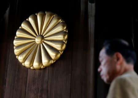 A visitor walks near the Imperial chrysanthemum emblem at the Yasukuni Shrine in Tokyo, Japan, December 29, 2016. REUTERS/Toru Hanai