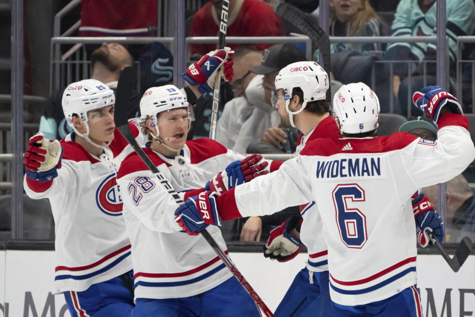 Montreal Canadiens forward Juraj Slafkovsky, forward Christian Dvorak, forward Josh Anderson and defenseman Chris Wideman, from left, celebrate a goal against the Seattle Kraken during the second period of an NHL hockey game, Tuesday, Dec. 6, 2022, in Seattle. (AP Photo/Stephen Brashear)