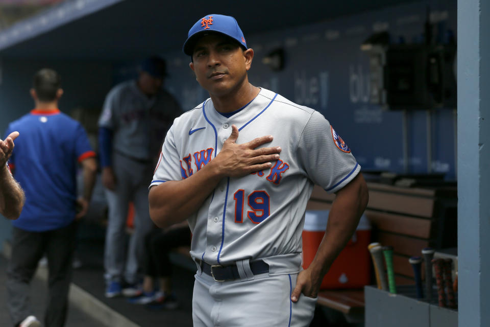 FILE - New York Mets manager Luis Rojas talks with a fan before a baseball game against the Los Angeles Dodgers in Los Angeles, in this Sunday, Aug. 22, 2021, file photo. Luis Rojas was let go as manager of the New York Mets on Monday, Oct. 4, 2021, after two losing seasons. The team declined its option on Rojas’ contract for 2022, making the announcement a day after finishing third in the NL East at 77-85 in Steve Cohen’s first year of ownership. (AP Photo/Alex Gallardo, File)