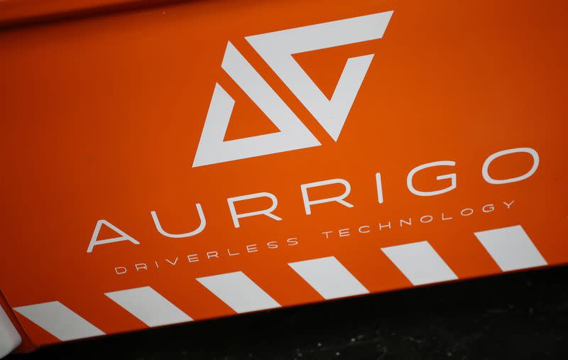 A company logo is seen on the side of an autonomous ‘Auto-Shuttle’ vehicle inside the Aurrigo factory in Coventry