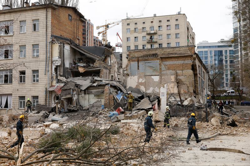 Rescuers work at the site of a building damaged by a Russian missile strike, in Kyiv