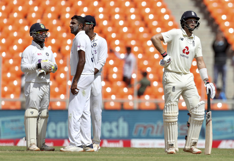 England's captain Joe Root, right, awaits third umpire's decision before he is given out on a delivery of India's Ravichandran Ashwin, second left, during the third day of fourth cricket test match between India and England at Narendra Modi Stadium in Ahmedabad, India, Saturday, March 6, 2021. (AP Photo/Aijaz Rahi)