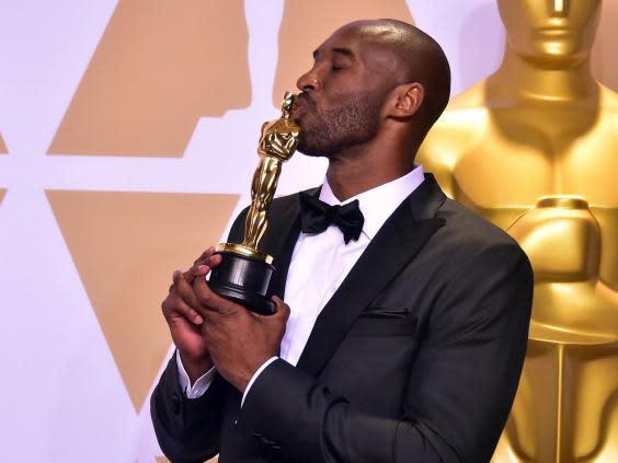 Kobe Bryant celebrating winning the Oscar (AFP)