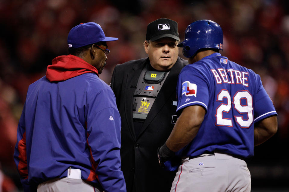 ST LOUIS, MO - OCTOBER 19: Adrian Beltre #29 (R) of the Texas Rangers and manager Ron Washington (L) argue a call with home plate umpire Jerry Layne after Beltre was called out after a disputed foul ball in the ninth inning during Game One of the MLB World Series against the St. Louis Cardinals at Busch Stadium on October 19, 2011 in St Louis, Missouri. The Cardinals won 3-2. (Photo by Rob Carr/Getty Images)