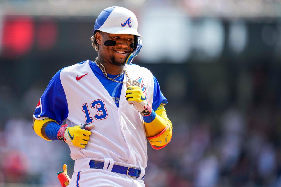 Ronald Acuna Jr. reacts after hitting a lead off home run against the Miami Marlins during the first inning at Truist Park on Saturday.