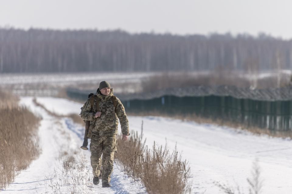 A member of the Ukrainian border guard patrols a crossing with Russia and Belarus on Feb. 14, 2022.