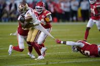 Kansas City Chiefs defensive end Frank Clark, right, tries to tackle San Francisco 49ers running back Raheem Mostert, left, during the first half of the NFL Super Bowl 54 football game Sunday, Feb. 2, 2020, in Miami Gardens, Fla. (AP Photo/David J. Phillip)