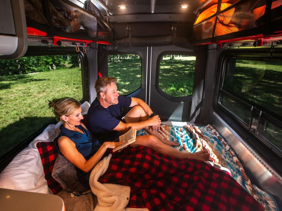 people on bed of the Airstream Interstate 19X