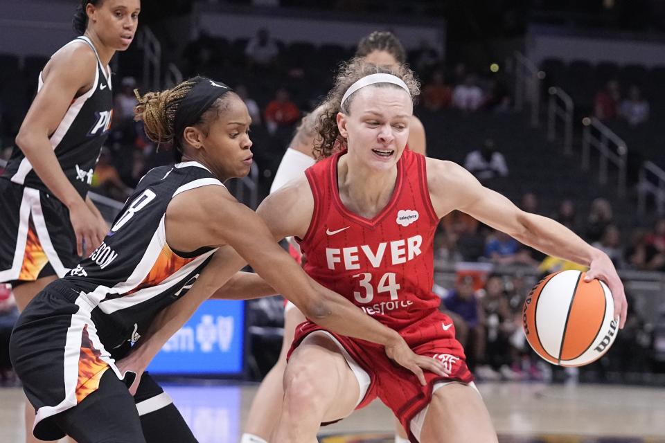 Indiana Fever's Grace Berger (34) is defended by Phoenix Mercury's Moriah Jefferson during the first half of a WNBA basketball game, Tuesday, Aug. 1, 2023, in Indianapolis. (AP Photo/Darron Cummings)