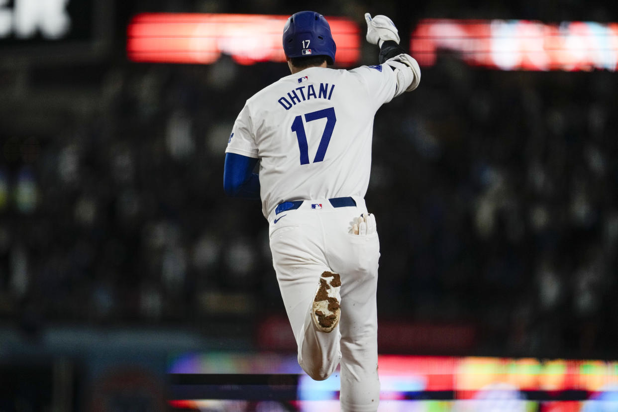 Los Angeles Dodgers designated hitter Shohei Ohtani (17) runs the bases after hitting a home run during the fifth inning of a baseball game against the Colorado Rockies in Los Angeles, Friday, Sept. 20, 2024. Max Muncy also scored. (AP Photo/Ashley Landis)