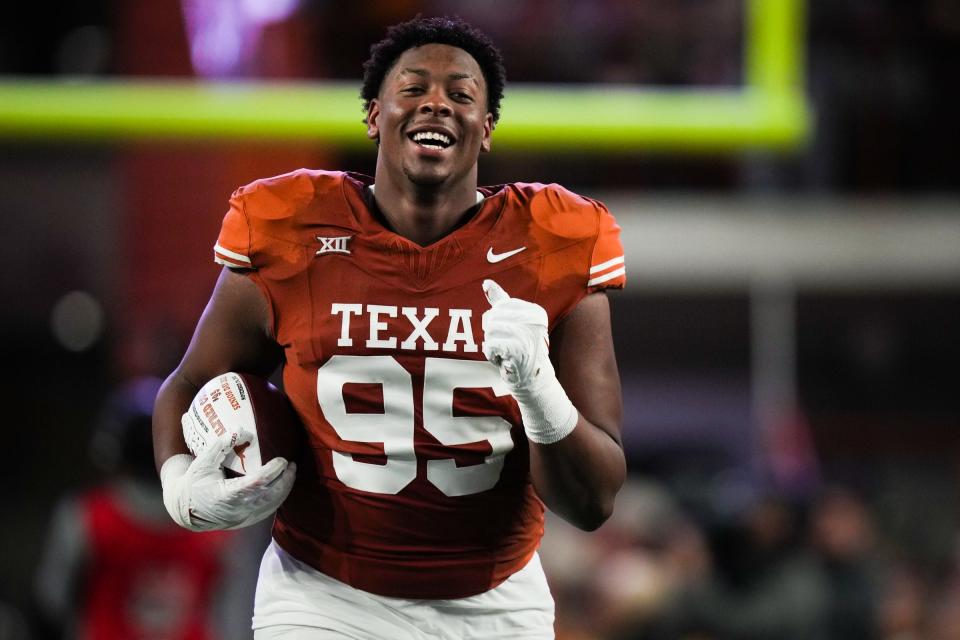 Texas defensive lineman Alfred Collins runs down the field during the Senior Night celebration before the Longhorns' game against Texas Tech last season. Collins decided to come back for a fifth season and leads a revamped defensive tackle rotation for Texas.