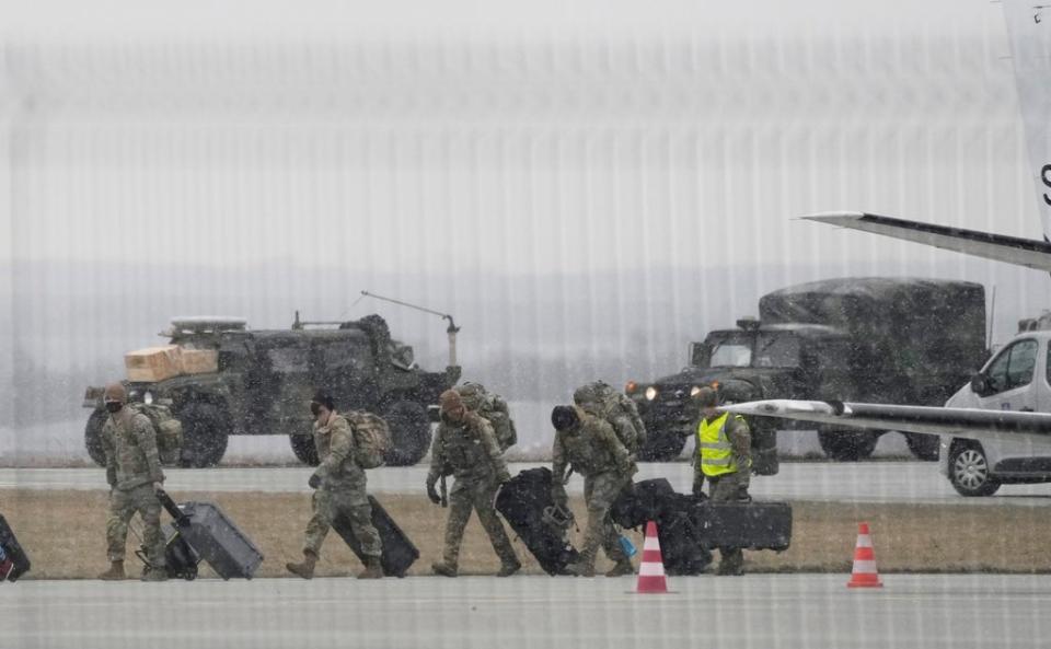 US army troops unloading vehicles from a transport plane after arriving in south-eastern Poland, on Sunday (Czarek Sokolowski/AP) (AP)