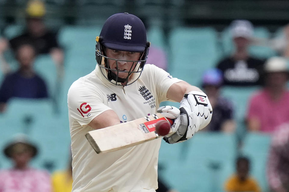England's Zak Crawley hits a boundary off Australia's Pat Cummins during the fifth day of their Ashes cricket test match in Sydney, Sunday, Jan. 9, 2022. (AP Photo/Rick Rycroft)