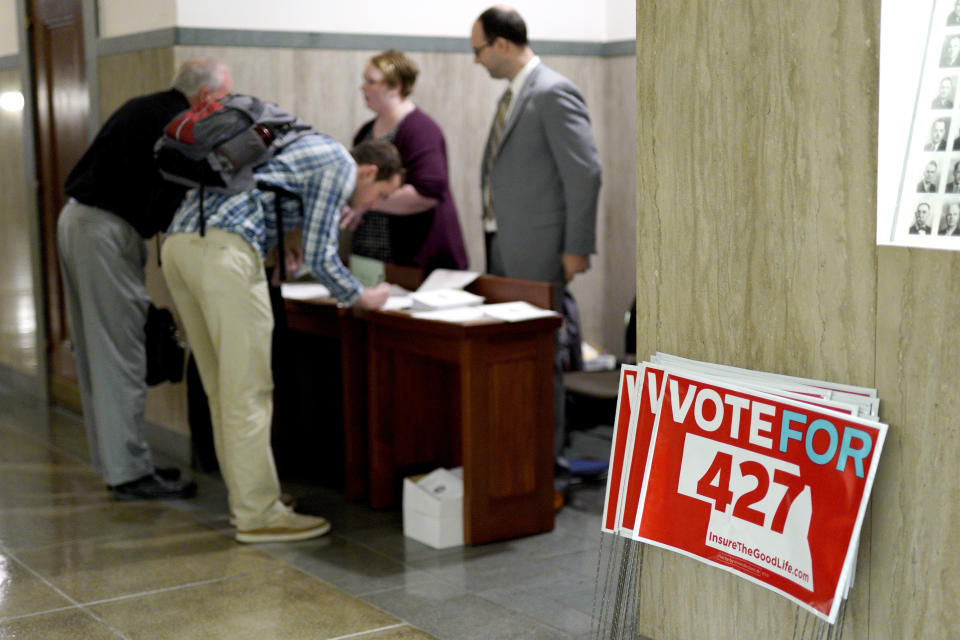 In this Oct. 16, 2018 photo, yard signs are stacked outside a public hearing in Lincoln, Neb., for Initiative 427, the Medicaid Expansion Initiative. For nearly a decade, opposition to Obama's health care law has been a winning message for Nebraska Republicans, helping them take every statewide office, dominate the Legislature and hold all of the state's congressional seats. But in the upcoming general election, even the most strident opponents of the Affordable Care Act are acknowledging an odd reality: there's a good chance the voters who support them will also approve a ballot measure expanding Medicaid. (AP Photo/Nati Harnik)