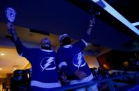 Tampa Bay Lightning fans Carson Cain, 13, and Cooper Hollis, 13, cheer ahead of an NHL Stanley Cup finals hockey game against the Dallas Stars as fans gather on Thunder Alley to watch as the game is being aired live outside of Amalie Arena, Monday, Sept. 28, 2020, in Tampa, Fla. (Ivy Ceballo/Tampa Bay Times via AP)