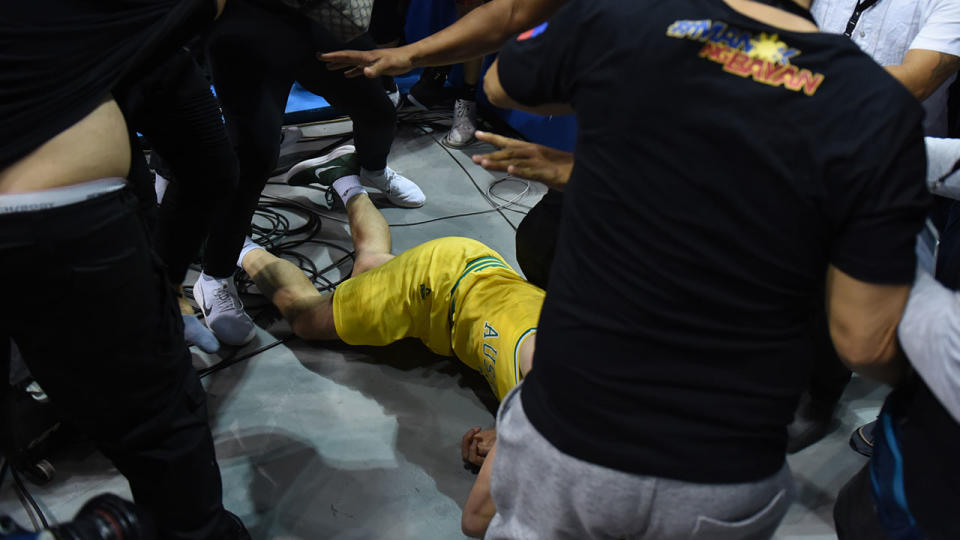 Goulding lays on the floor as players from benches run to their teammates who figured in a brawl during the match between Australia and the Philippines for the FIBA Asian Qualifiers held at the Philippine Arena in the province of Bulacan, north of Manila in 02 July 2018. Australia beat the Philippines by default following a brawl in the third quarter that shocked basketball fans all over the world. (Photo by George Calvelo/NurPhoto via Getty Images)