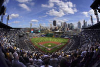 The Pittsburgh Pirates, along the third baseline, and the Chicago Cubs stand for the national anthem before the Pirates' home-opener baseball game at PNC Park in Pittsburgh, Tuesday, April 12, 2022. (AP Photo/Gene J. Puskar)