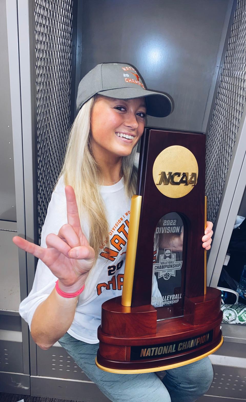 Freshman Emma Halter, a Roncalli High School alum, poses for a photo with the NCAA National Championship trophy following Texas' victory over Louisville in the Division I volleyball final.