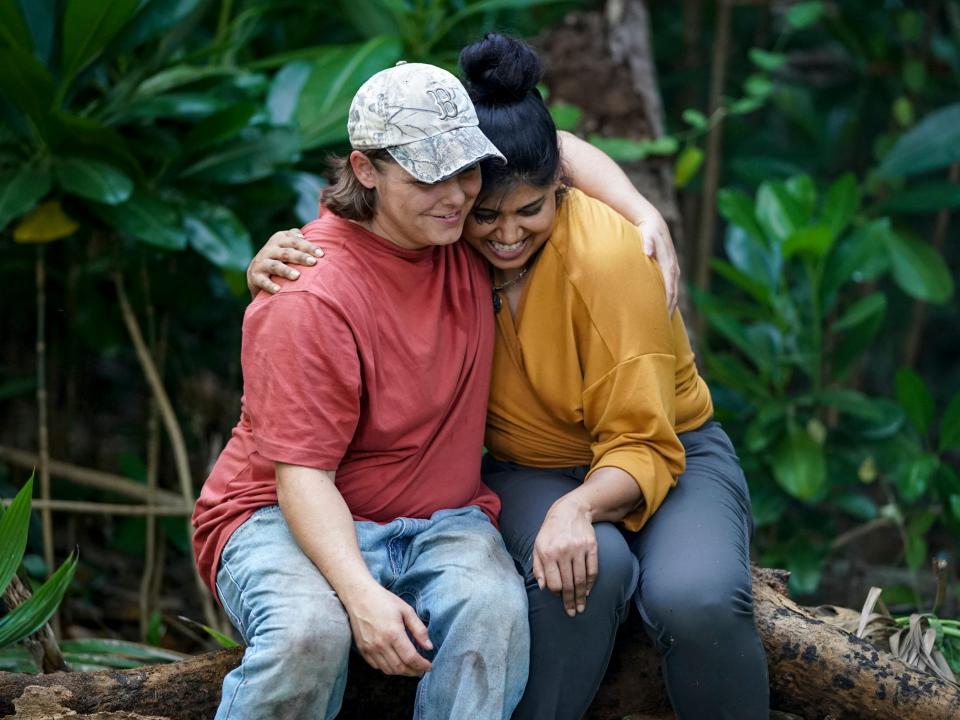 Elaine Stott hugging Karishma Patel in the woods on survivor