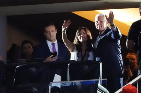 U.S. Vice President Mike Pence and his wife Karen Pence wave before a rally for U.S. President Donald Trump at the Amway Center in Orlando