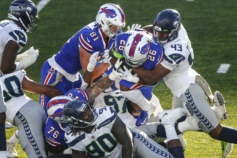 Seattle Seahawks Carlos Dunlap (43) tackles Buffalo Bills' Devin Singletary (26) during the second half of an NFL football game Sunday, Nov. 8, 2020, in Orchard Park, N.Y. (AP Photo/John Munson)