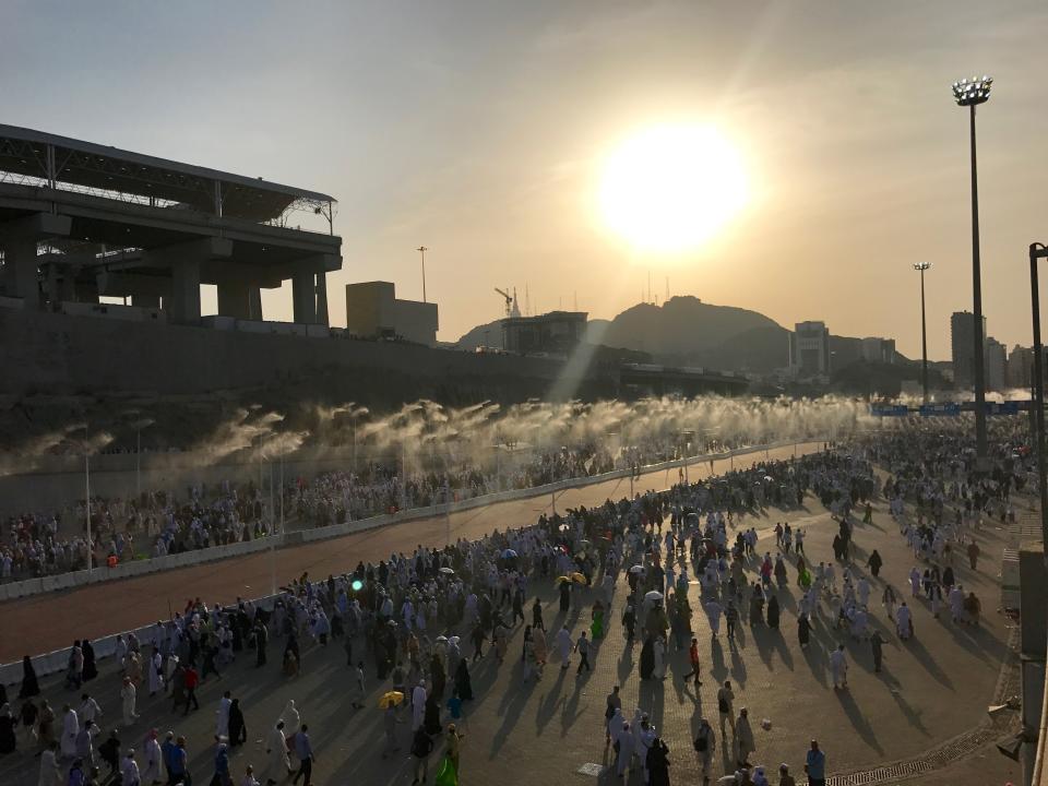 <p>Prospective pilgrims walk on the road, which has water spray cooling system, to stone Jamarat pillars that symbolize the devil as a part of the annual Islamic hajj pilgrimage during the first day of Eid Al-Adha (Feast of Sacrifice) in Mecca, Saudi Arabia on Sept.3, 2017. (Photo: Firat Yurdakul/Anadolu Agency/Getty Images) </p>