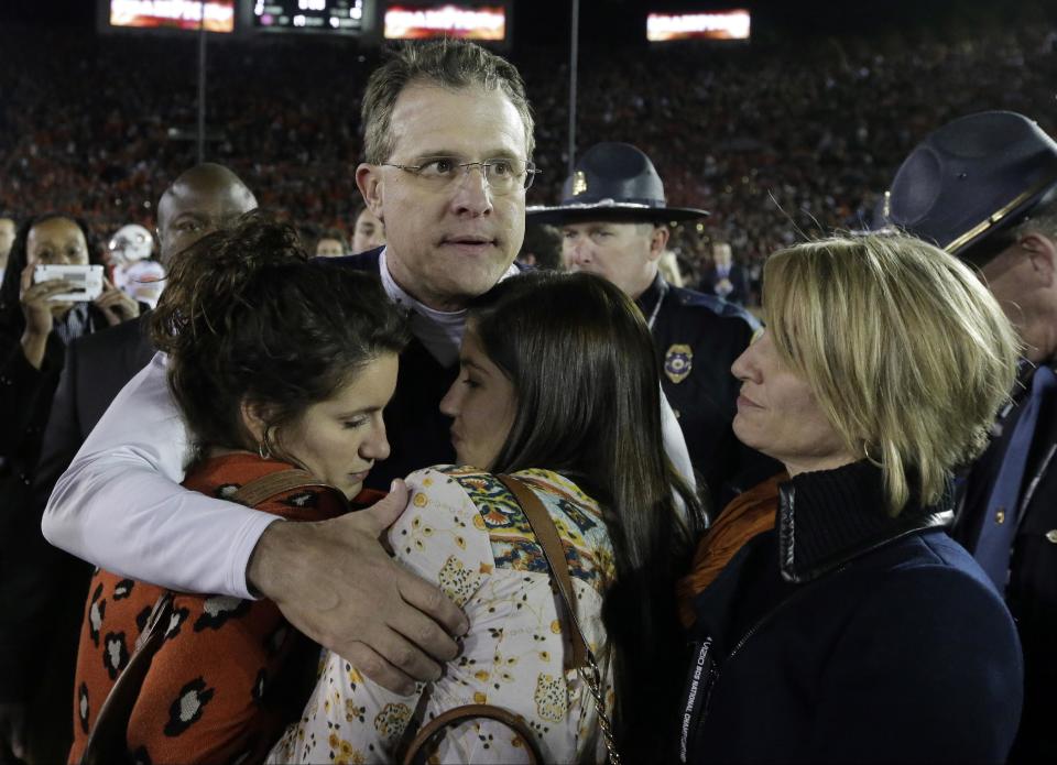 Auburn head coach Gus Malzahn is hugged following the NCAA BCS National Championship college football game against Florida State Monday, Jan. 6, 2014, in Pasadena, Calif. Florida State won 34-31. (AP Photo/Chris Carlson)