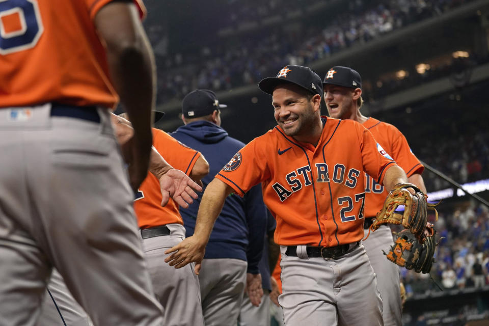 Houston Astros' Jose Altuve (27) celebrates with teammates after Game 5 of the baseball American League Championship Series against the Texas Rangers Friday, Oct. 20, 2023, in Arlington, Texas. The Astros won 5-4. (AP Photo/Julio Cortez)