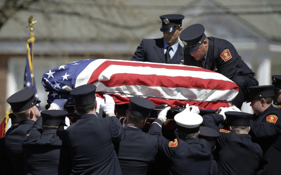 Firefighters hoist the casket of Michael R. Kennedy back onto their truck outside Holy Name Church in Boston, after Kennedy's funeral Thursday, April 3, 2014. Kennedy and Boston Fire Lt. Edward J. Walsh were killed Wednesday, March 26, 2014 when they were trapped in the basement of a burning brownstone during a nine-alarm blaze.(AP Photo/Stephan Savoia)