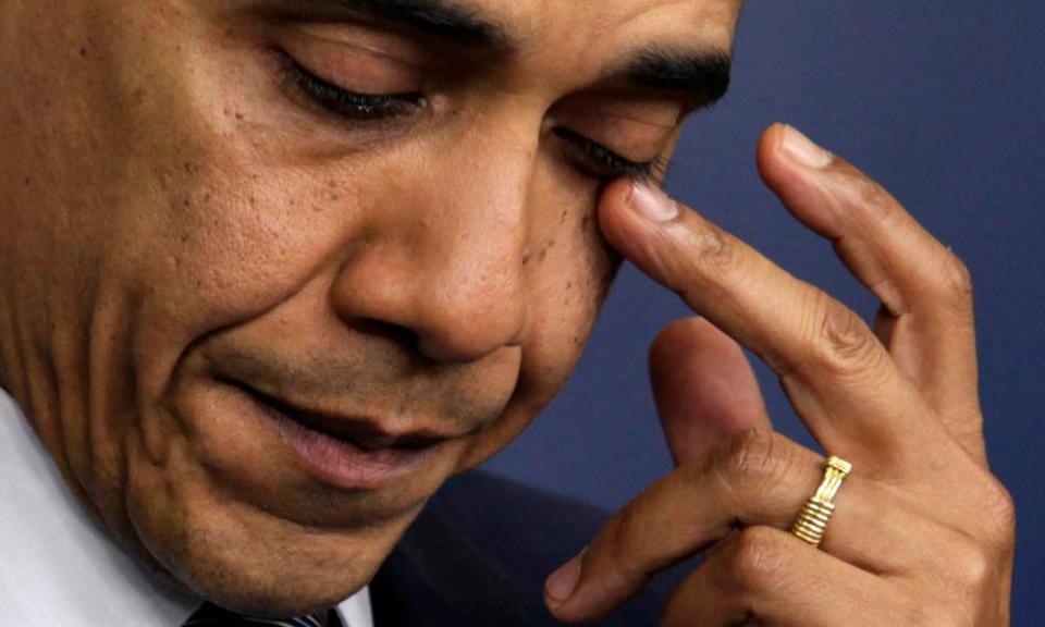 Barack Obama wipes a tear as he speaks about the shooting at Sandy Hook elementary school.