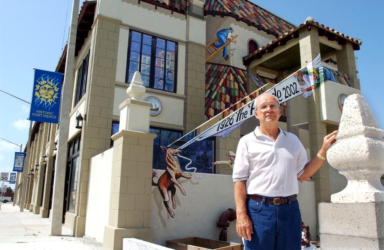 Bob Brackett poses in 2002 on the north side of the Arcade Building on U.S. 1 in Fort Pierce, where artists painted murals. Brackett renovated the building along with several historic structures in Vero Beach, including an old theater and courthouse.