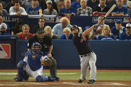Oct 17, 2016; Toronto, Ontario, CAN; Cleveland Indians first baseman Mike Napoli (right) hits a solo home run in front of Toronto Blue Jays catcher Russell Martin (left) during the fourth inning in game three of the 2016 ALCS playoff baseball series at Rogers Centre. Mandatory Credit: Dan Hamilton-USA TODAY Sports