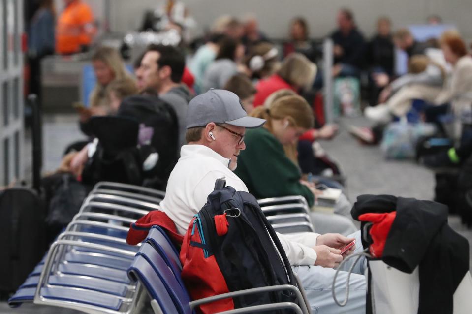 Travelers wait for their flight at Akron-Canton Airport in Green on Thursday. Lisa Dalpiaz, airport spokeswoman, said airport crews are prepared to keep the runways clear for flights. However, she said passengers should check with airlines before they come to the airport for any delays or cancellations.