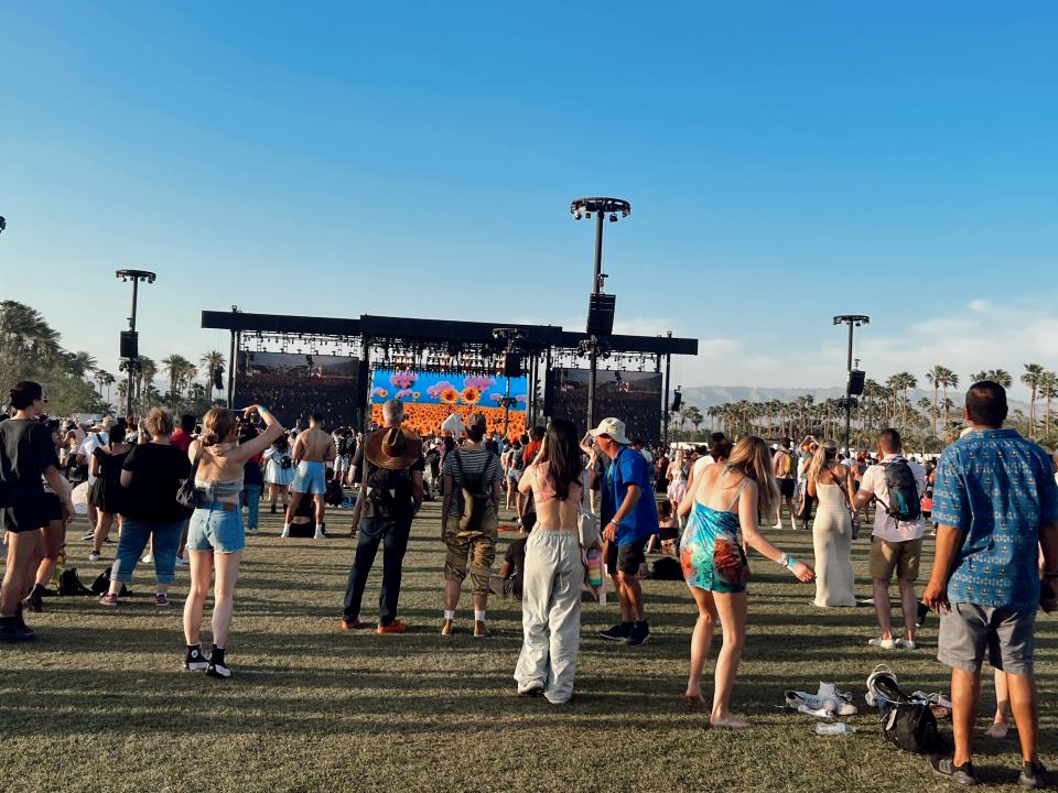 people dancing in crowd at coachella during day time festival