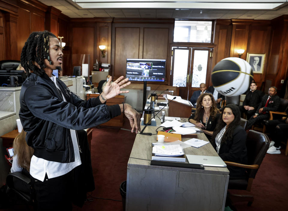 Memphis Grizzlies player Ja Morant, demonstrates a chest pass, while testifying in Judge Carol Chumney's courtroom at Shelby County Circuit Court on Monday, Dec. 11, 2023, in Memphis, Tenn. The hearing is to determine whether Morant used self defense during a fight last summer at his home. (Mark Weber/Daily Memphian via AP)