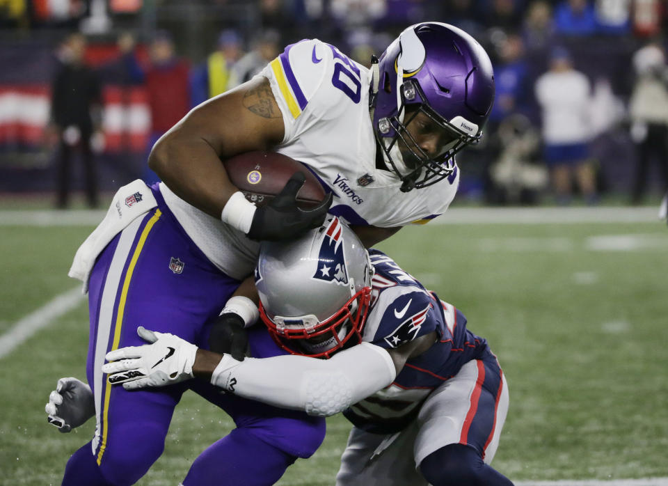 New England Patriots defensive back Jason McCourty, right, tackles Minnesota Vikings fullback C.J. Ham during the first half of an NFL football game, Sunday, Dec. 2, 2018, in Foxborough, Mass. (AP Photo/Elise Amendola)