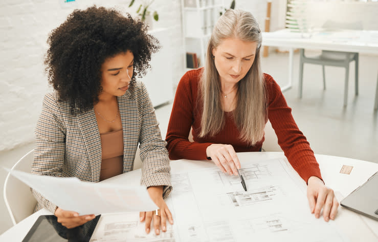 A financial advisor working with a client to align her retirement goals with important age milestones.